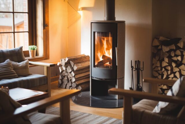 Un salon avec un poêle à bois moderne et lumineux